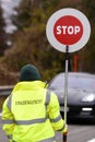 Road supervisor from behind with stop sign - road block due to a construction site in Salzkammergut, Austria, Europe